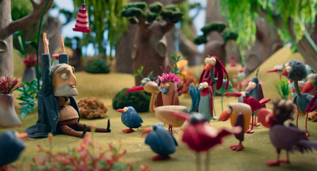 Kunstmatige scène met kleurrijke poppen en figuren in een bosrijke omgeving, geschikt voor een filmtheater website. Beeld toont een creatieve en speelse setting met diverse poppen en dieren, ideaal vo.
